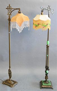 Two Victorian Brass Floor Lamps, each having elaborate shades, heights 59 inches and 60 inches.
