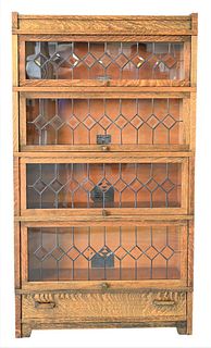 Globe Wernicke Art Mission Oak Stack Bookcase, having four leaded glass doors, plus drawer, height 62 inches, width 34 1/2 inches.