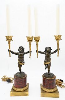 Pair of French Bronze Candelabras, having winged putti holding a flaming torch in each hand, on circular rouge marble and bronze bases, height 23 inch