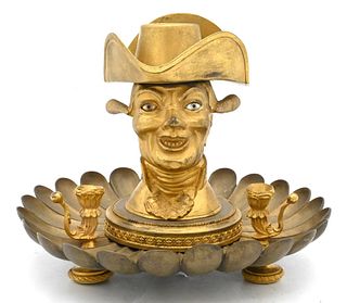 Bronze and Gilt Bronze Inkwell, having figure with tilting hat, height 6 inches.