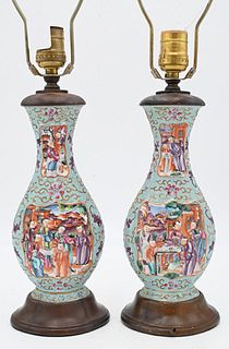 Pair of Chinese Famille Rose Porcelain Vases, having molded flower and vine decoration, panels with painted figures, made into table lamps, height 19 