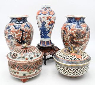 Five Piece Group of Imari Porcelain, to include two reticulated covered boxes; a pair of vases, height 10 inches; along with a vase on carved stand.