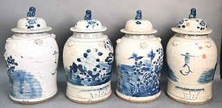 Group of Four Chinese Blue and White Jars, having painted flower and birds, covers mounted with foo dog handles, height 19 inches.