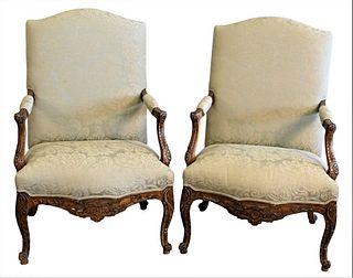 Pair of Louis XV Style Upholstered Open Armchairs, each with carved frames, height 42 inches, width 28 inches.