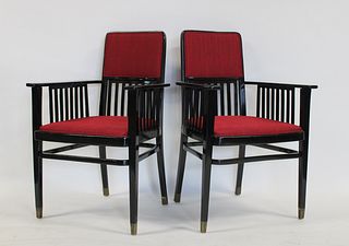 A Midcentury Pair Of Ebonised Arm Chairs.