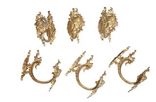 Set of Six French Gilt Bronze Figural Curtain Tiebacks, early 20th c., the scroll decorated back plate issuing a scrolled arm with a pierced winged pu