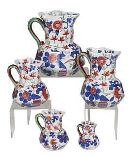 Set of Five Ironstone Octagonal Form Graduated Pitchers, early 20th c., with integral green snake or dragon handles, the sides with floral decoration 