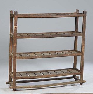 French Provincial Carved Pine Drying Rack, 19th c., with four galleried plank shelves on block feet, joined by rectangular stretchers, H.- 49 3/4 in.,
