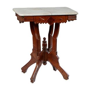 American Carved Walnut Marble Top Lamp Table, late 19th c., the rounded corner figured white marble over an incise carved and reeded skirt, on four in