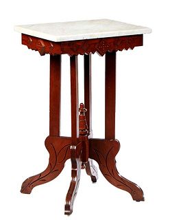 American Carved Walnut Marble Top Lamp Table, late 19th c., the figured white marble over an incise carved sawtooth skirt, on four flat rectangular le