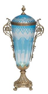 Blue Cut-to-Clear Bronze Mounted Blue Glass Covered Urn, 20th c., the bronze mounted lid over a tapering body with scrolled bronze handles, to a bronz