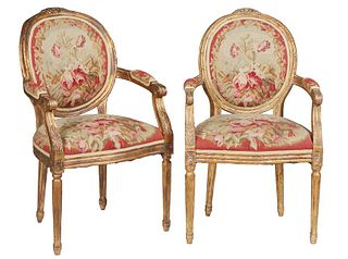 Pair of French Louis XVI Style Carved Gilded Beech Fauteuils, early 20th c., the floral carved canted curved upholstered back over upholstered arms an