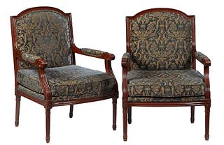 Pair of Louis XVI Style Carved Beech Fauteuils, 20th c., the arched canted upholstered back over upholstered arms and an upholstered bowed seat, on tu