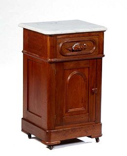 American Carved Walnut Marble Top Nightstand, 19th c., the ogee edge rounded corner figured white marble over a frieze drawer with a leaf carved pull,