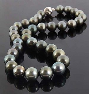 Graduated Strand of Thirty-Five Dark Grey Tahitian Pearls, ranging from 11-14mm, with a 14K white gold ball clasp, l.- 18 in., with appraisal.