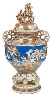 Japanese Porcelain Lidded Urn, 20th c., with gilt decoration on a blue ground, the lid with a gilt Foo dog handle over an everted rim flanked by pierc
