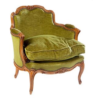 French Louis XV Style Carved Cherry Bergere, 20th c., the arched serpentine floral carved upholstered back to upholstered arms and a removable bowed s