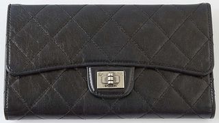 Chanel Reissue Bifold Black Wallet, c. 2006-2008, the calf leather quilted with brushed silver accents, opening to four bill compartments, one coin po