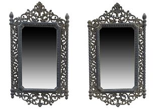 Pair of Renaissance Style Ebonized Spelter Mirrors, early 20th c., with a pierced floral crest flanked by flame topped pierced sides to a pierced bott