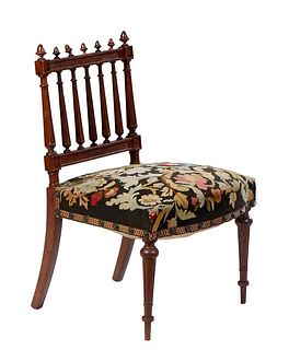 French Henri II Style Carved Oak Armchair, c. 1880, the canted tapered reeded spindled back with acorn tops, flanked by acorn finials, over a bowed tr