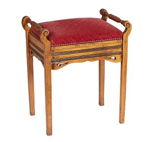 French Carved Beech Lift Top Music Bench, c. 1900, the cushioned seat over interior storage, flanked by ring turned tapered handles, on tapered square
