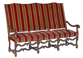 French Louis XIII Style Carved Oak Settee, 20th c., the canted serpentine upholstered back over an upholstered seat flanked by scrolled arms, on cabri