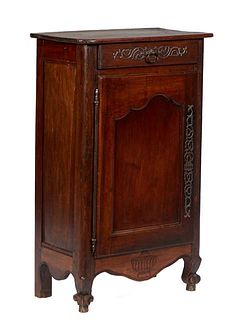 French Provincial Louis XV Style Carved Oak Confiturier, 19th c., the rounded corner top over a frieze drawer with a long iron escutcheon, above a cup