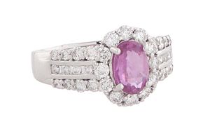 Lady's 14K White Gold Dinner Ring, with an oval 1.17 ct. pink sapphire, atop a border of round diamonds, the triple split shoulders of the band also m