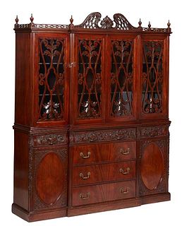 Indonesian English Style Carved Mahogany Breakfront Bookcase, 20th/21st c., the broken arch pierced crest over a breakfront crown, above two central m