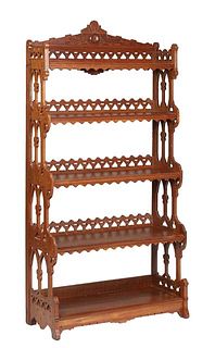 American Eastlake Carved Walnut Open Bookcase, 1890, the arched incised crest over a geometric pierced 3/4 gallery, above four reeded edge graduated s