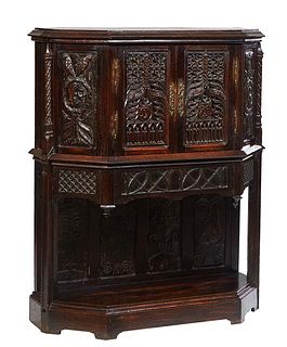 French Gothic Carved Oak Sideboard, 19th c., of hexagonal form, the stepped ogee edge crown over double doors with relief Gothic arch decorations, fla