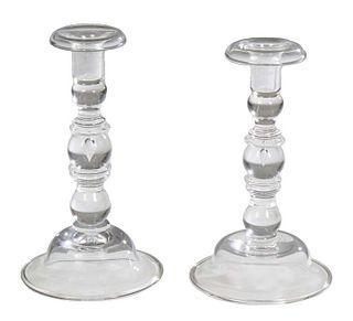 Pair of Steuben Blown Glass Candlesticks, each with a bell form foot and a shaft with a tear drop trapped bubble, and spool form nozzles with wide rim