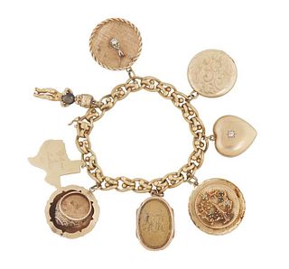 18K Yellow Gold Charm Bracelet, stamped Italy, with eight 14K Yellow Gold Charms, consisting of two lockets, a 1964 University of Texas class ring, mo