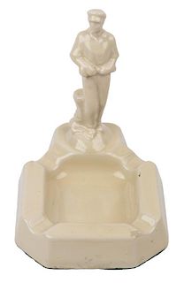 AN EARLY SOVIET PORCELAIN ASHTRAY WITH A FIGURE OF A WORKER, CIRCA 1920-1930S