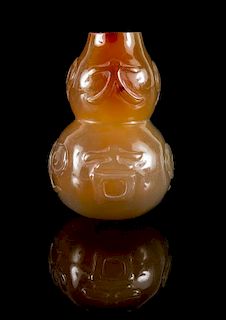 * A Carved Carnelian Agate Gourd-Form Snuff Bottle Height 2 3/4 inches.
