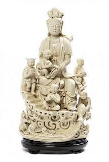 * A Chinese Blanc-de-Chine Porcelain Figural Group of Guanyin and Attendants Height 18 3/4 inches.