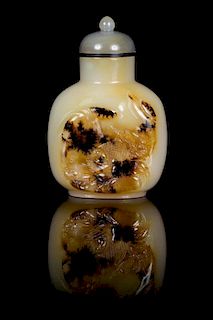 * A Chinese Carved Agate Snuff Bottle Height 3 1/8 inches.