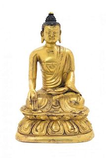 A Sino-Tibetan Gilt Bronze Figure of Buddha Shakyamuni Height 6 3/4 inches.