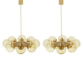 A pair of mid-century modern brass globe chandeliers