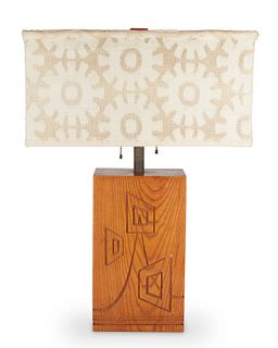A mid-century modern carved wood table lamp