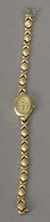 14K gold ladies wristwatch with 14K gold band. 
lg. 7 in.; 18.6 grams total weight
