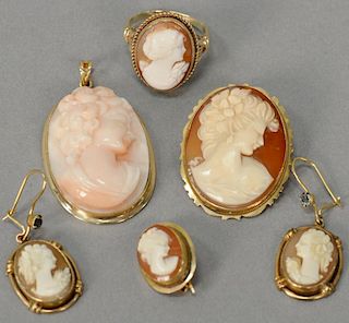 Six piece cameo lot including coral cameo medallion, brooch, pair of earrings, ring, and earring, in 14K settings. ring size 7