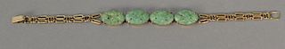 Gold and jade bracelet with four green jade medallions. lg. 8 in.