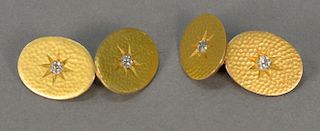 Pair of 18K gold cuff links each set with center diamond. 
13.5 grams