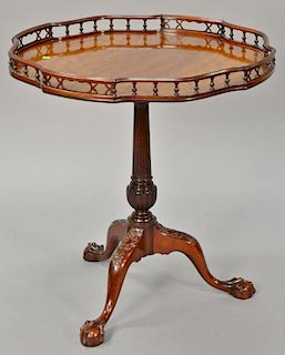 Margolis mahogany Chippendale table with gallery on carved shaft set on tripod base ending in ball and claw feet, signed Margolis wi...