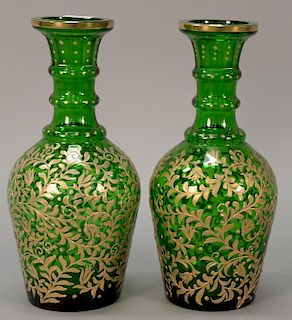 Pair of large green glass decanters decorated with heavy raised gilt decorated scrolling leaves, possibly Moser.
ht. 14 in.