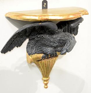Pair of shaped gilt decorated wall shelves mounted on black eagles set on gilt perch over vase, 19th century. 
ht. 19 in.; wd. 17 in...