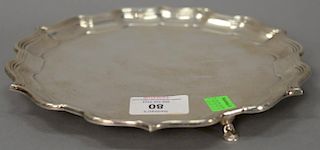 English silver shaped salver on three feet with mark of DWJW. 
dia. 8 1/4 in.; 13.1 t oz.