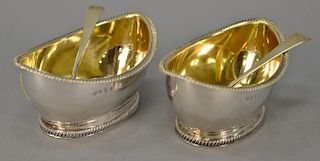 Pair of English silver salts each oval with gardrooned on top edge and bottom footed base, each with vermeil bowls and non matching ...