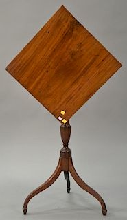 Federal mahogany candlestand having square tip top on urn carved shaft on tripod base, circa 1800. 
ht. 30 in.; top: 17 3/4" x 18 1/4"